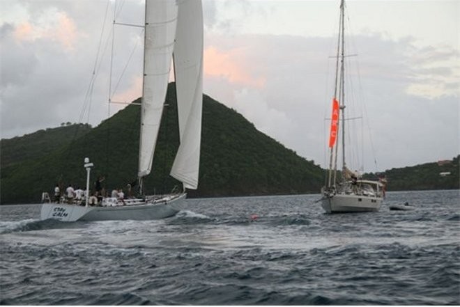 Stay Calm (Swan 70 ) crosses the finish line right in front of the Finish Line boat Chandelle - ARC Atlantic 2009 © World ARC - http://www.worldcruising.com/arc/